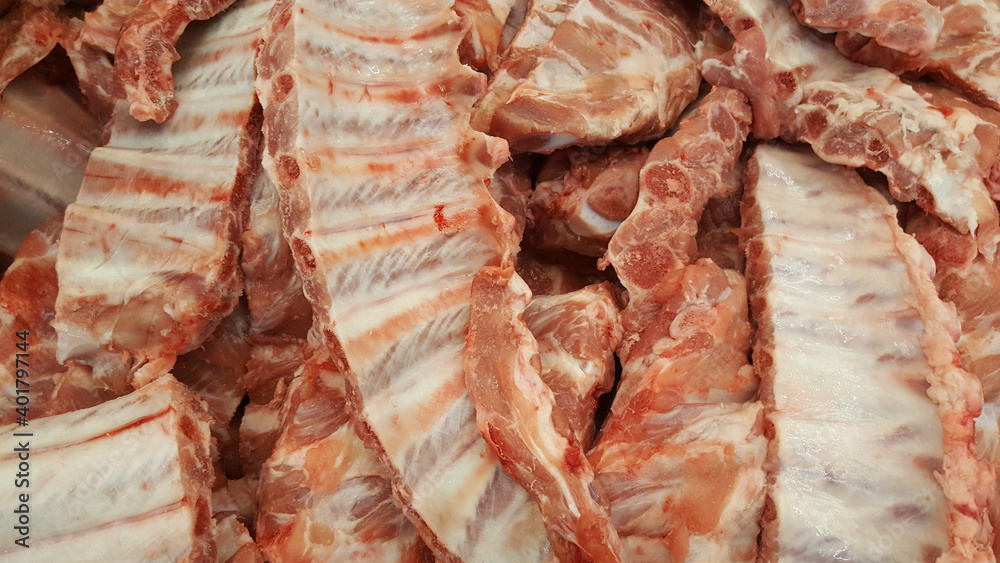 Raw fesh spare ribs on a wooden surface.Raw pork meat - spare ribs or belly. Fresh meat and ingredients. Butchery, market.
