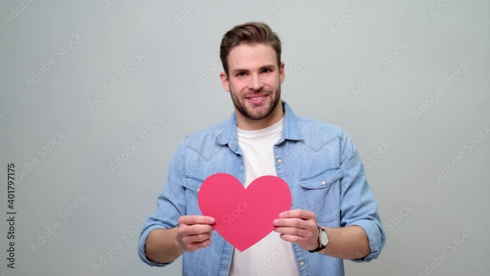 Portrait of charming man hold hand paper heart shaped card wear casual style shirt Portrait of charming man hold hand paper heart shaped card wear casual style shirt