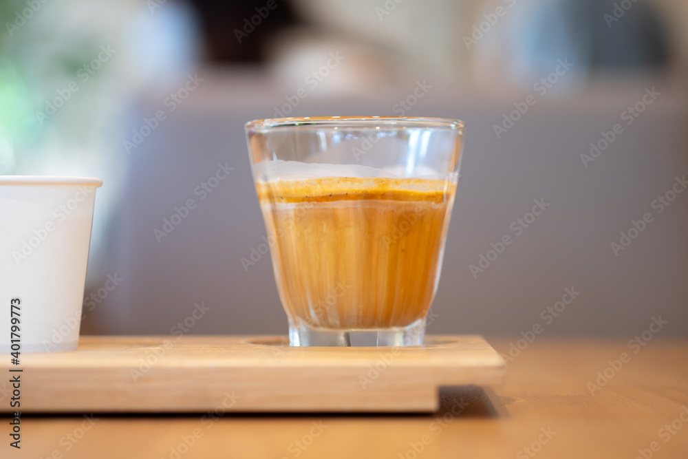 Dirty coffee. A glass of espresso shot mixed with cold fresh milk in coffee shop Dirty coffee. A glass of espresso shot mixed with cold fresh milk in coffee shop