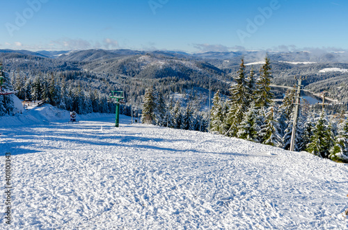 Beautiful panoramic view over the "Marisel" ski slope in winter season and Belis lake in the valley, Cluj county Romania.