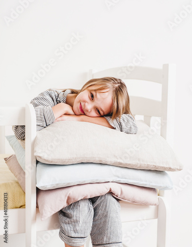 beautiful girl in pajamas on a light bed