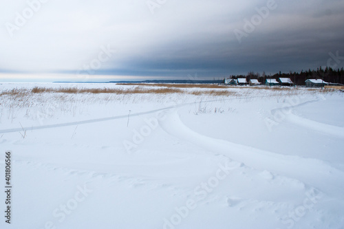Village at the covered with snow seaside © Aleksei