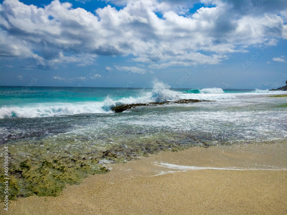 Ocean waves approaching coastal stones