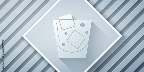Paper cut Glass of whiskey and ice cubes icon isolated on grey background. Paper art style. Vector.
