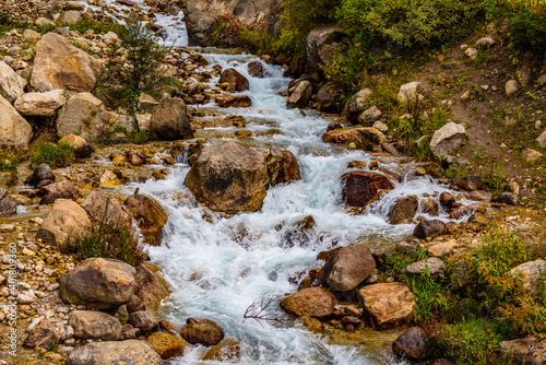View enroute to Chitkul through small waterfall rivulet, which is a popular tourist camping destination among backpacker and nature lovers for its natural beauty of Himalayas in Kinnaur region. photo