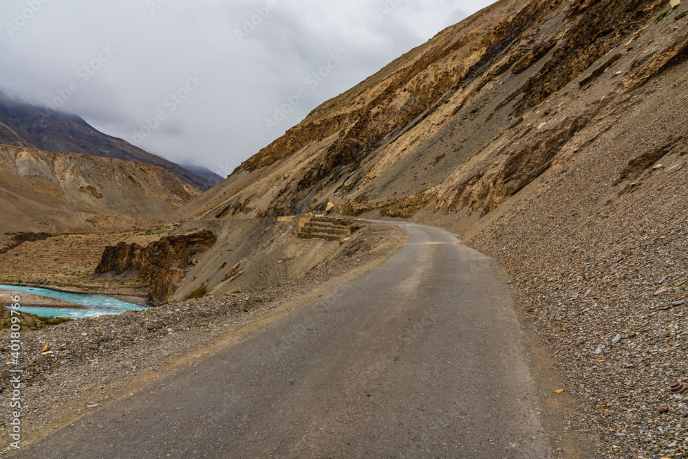 View from hilly mountain road Hindustan Tibet Road connecting Kaza city with Shimla state capital travelling through Himalayas mountains near Kalpa Kinnaur, Himachal Pradesh, India.