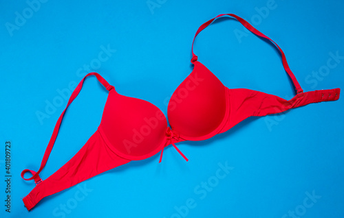Bright red bra on a blue background. copy space. top view