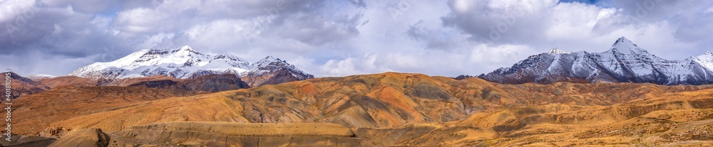 Panoramic Landscape of Spiti valley with snow capped mountains in background near Hikkim and Langza village of Kaza town in Lahaul and Spiti district of Himachal Pradesh, India.