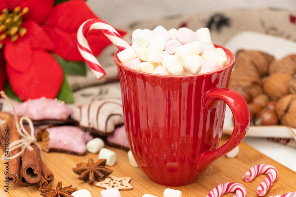 Christmas cocoa with marshmallow and Candy Cane in a red cup, close-up Christmas cocoa with marshmallow and Candy Cane in a red cup, close-up