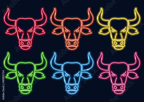 Neon frame. Bull head in neon style. Neon set in different colors. Symbol of 2021. Laser glowing lines on a black background.
