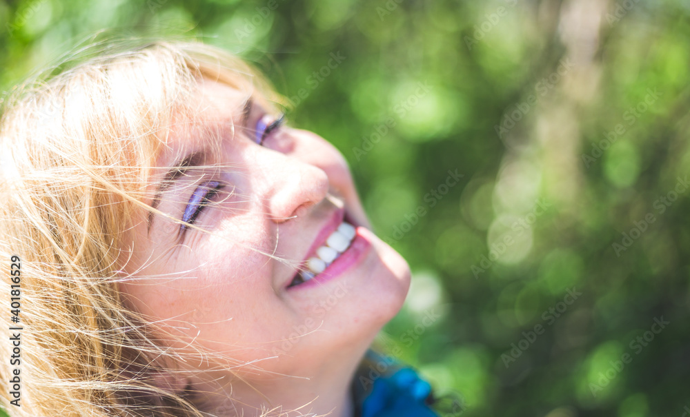 Smiling outdoors in spring. Portrait of smiling blonde girl outdoors Smiling outdoors in spring. Portrait of smiling blonde girl outdoors