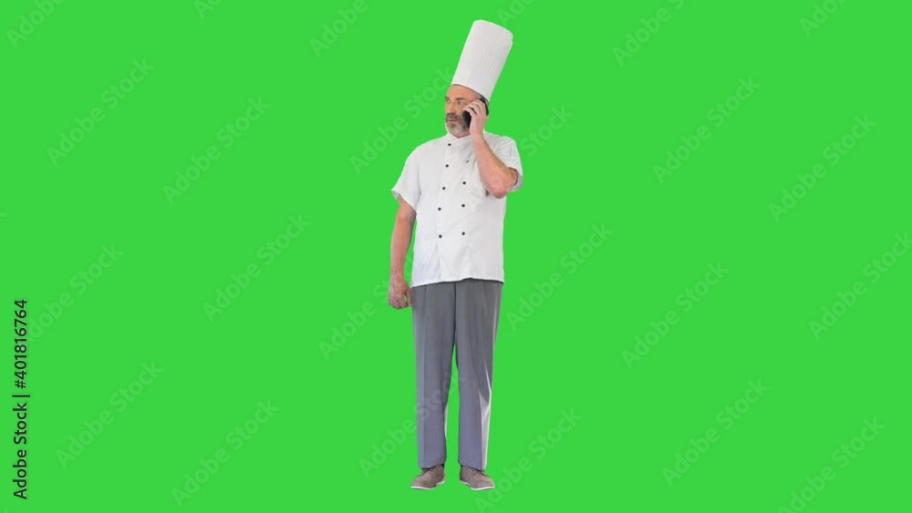 Concentrated male cook making a call on a Green Screen, Chroma Key. Concentrated male cook making a call on a Green Screen, Chroma Key.
