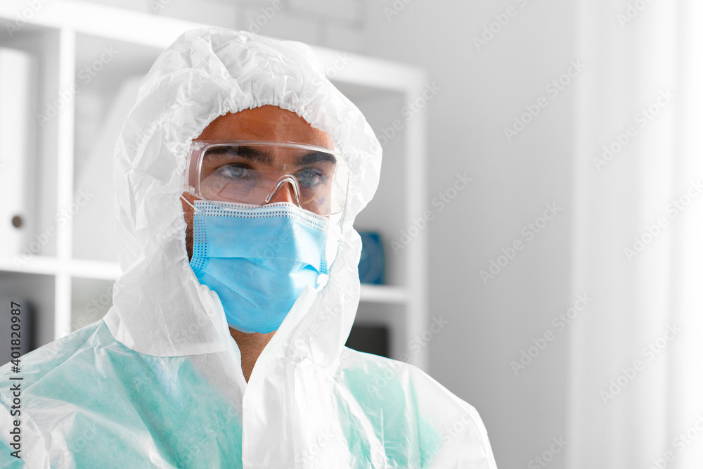 Male doctor in protective medical uniform in clinic Male doctor in protective medical uniform in clinic