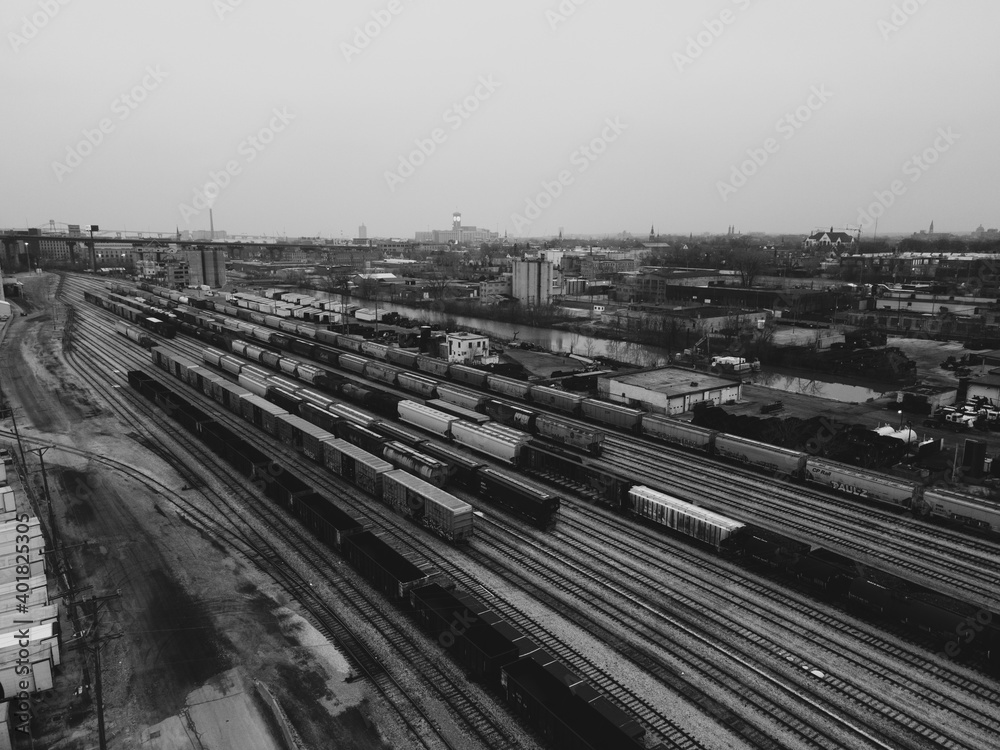 aerial view of large railroad tracks with a lot of trains in an urban environment