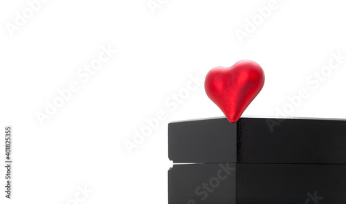 red heart on the corner of a black wooden box for gifts for valentine's day, objects isolated on white background with copy space. © Александр Беспалый
