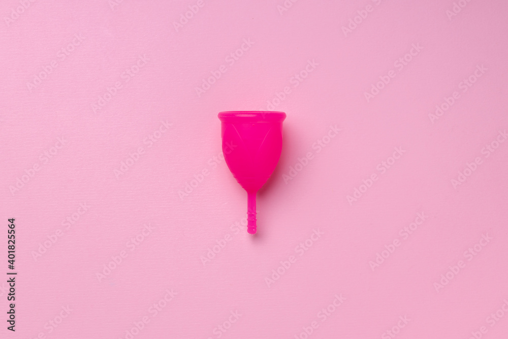 Menstrual cup on pink background top view Menstrual cup on pink background top view