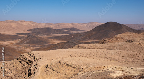 Desert landscape at Makhtesh Ramon Crater, nature reserve in Negev desert, Israel. Diversity of colors of the unique desert region - red, orange, yellow and black.