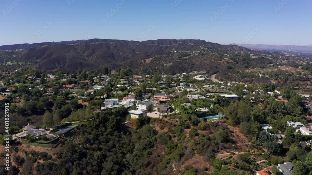 Wide aerial descending shot of a neighborhood in the hills above Sherman Oaks. HD at 60 FPS. Wide aerial descending shot of a neighborhood in the hills above Sherman Oaks. HD at 60 FPS.