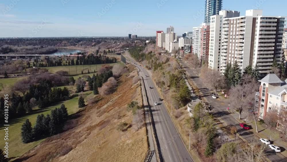 aerial fly over drop by rivers edge vip golf course park on a sunny fall day where high rise condomiums apartments and commercial buildings are located by the roadside as luxury living by bridge 2-3 aerial fly over drop by rivers edge vip golf course park on a sunny fall day where high rise condomiums apartments and commercial buildings are located by the roadside as luxury living by bridge 2-3