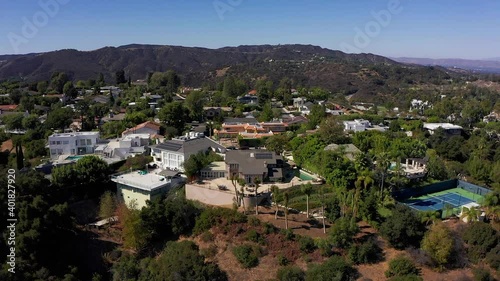 Reverse aerial shot of a neighborhood in the hills above Sherman Oaks. HD at 60 FPS. photo