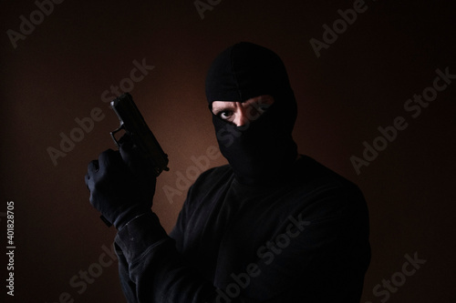 Series of a Caucasian burglar breaking into a house with gun in hand.