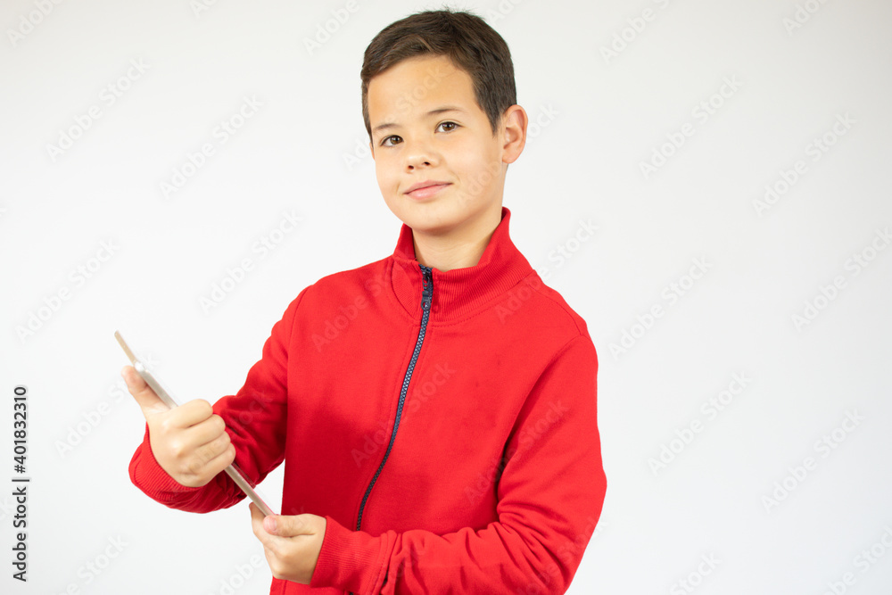 Portrait of a satisfied cute little kid playing games on tablet computer isolated over white background Portrait of a satisfied cute little kid playing games on tablet computer isolated over white background