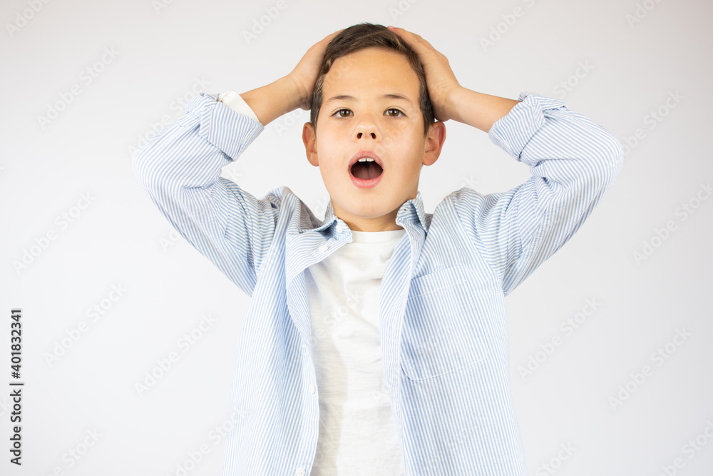 Beauty smiling amazed or surprised child boy gesturing hand isolated over white background Beauty smiling amazed or surprised child boy gesturing hand isolated over white background