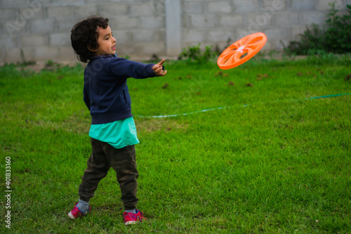 boy playing frisbee in the park photo