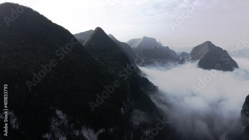 Dramatic Chinese karst mountain landscape, sunset cloudy aerial view photo