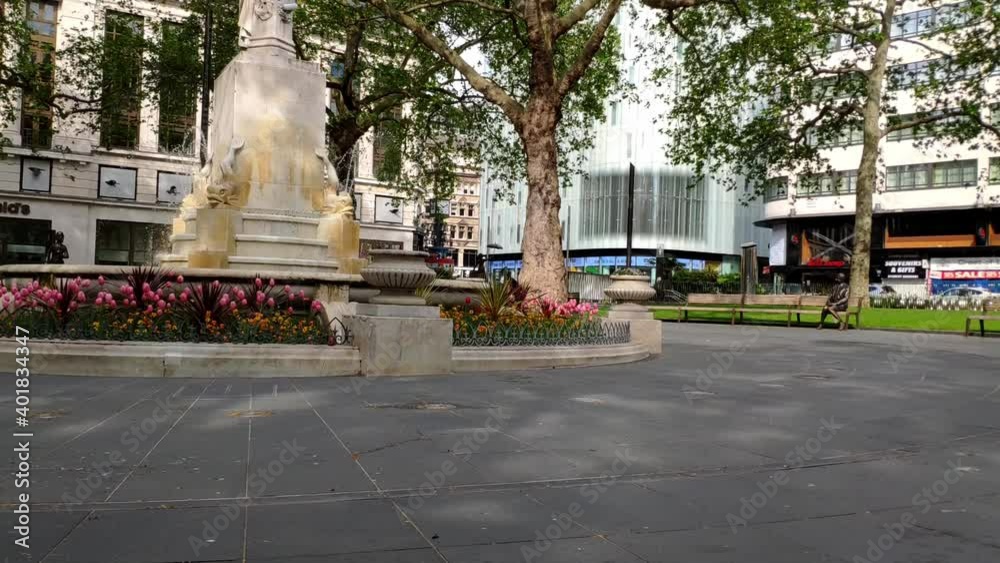 Famous Leicester Square in London city centre. Centre of the square where there is a fountain in Shakespeare's honour. It's a very quiet day with no people around since the city is in Covid lockdown Famous Leicester Square in London city centre. Centre of the square where there is a fountain in Shakespeare's honour. It's a very quiet day with no people around since the city is in Covid lockdown
