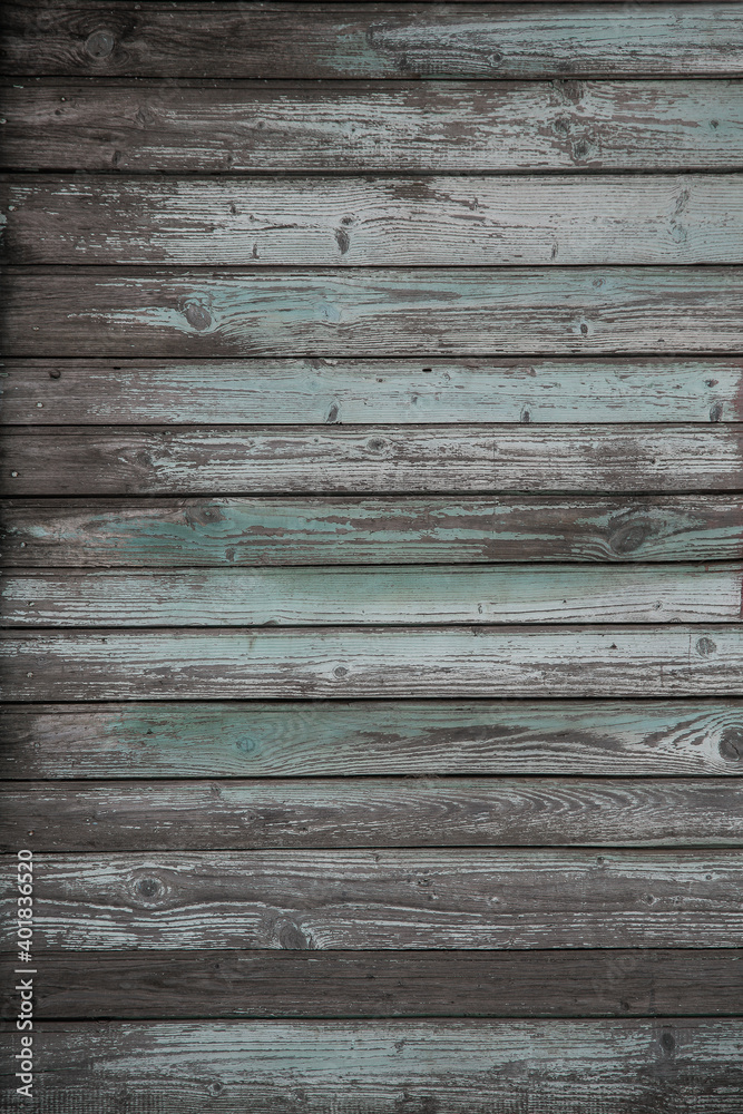 Obraz premium fragment of a fence made of old wooden boards with remnants of paint and nails, natural texture, background