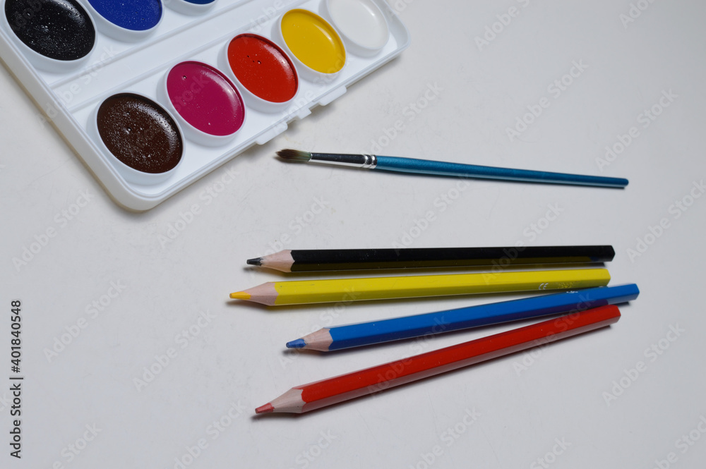 Naklejka premium paint for drawing watercolor, pencils and brush. on white background.