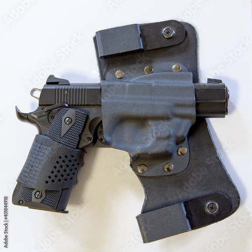 Handgun in a holster isolated in white background