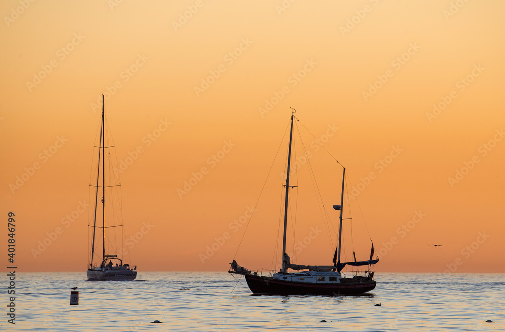 sailboats at sunset at Corona del Mar beach in Orange County California