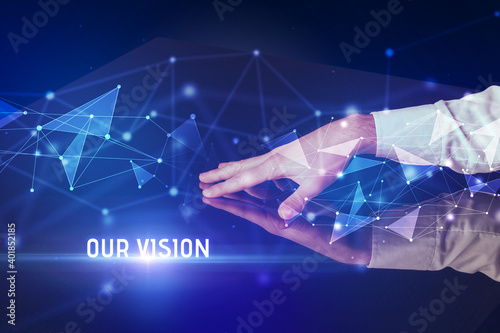 Businessman touching huge screen with OUR VISION inscription, modern technology business concept