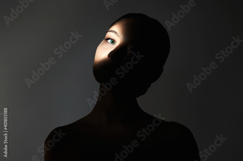 Obraz na plátně young woman with shadow ob the face