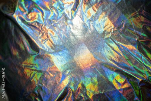 Iridescent fabric holographic background. Crumpled surface