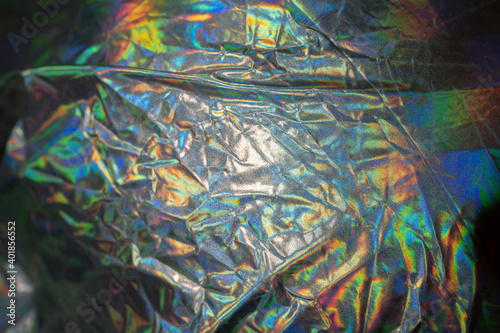 Iridescent fabric trendy cloth holographic background. Colorful chrome fabric.