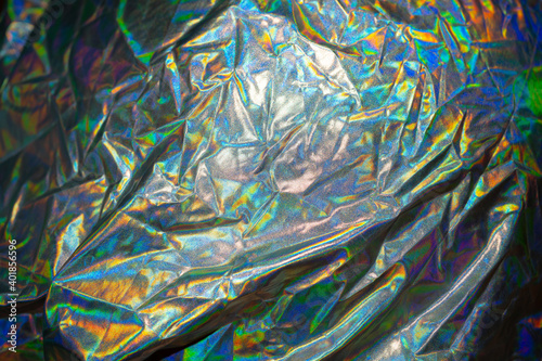 Iridescent fabric trendy holographic background. © Alex