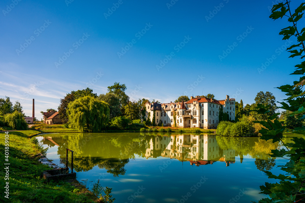 Güttmannsdorf Castle, a neo-Gothic castle on a small lake in Dobrocin, Poland.