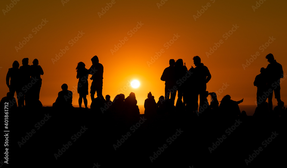 Silhouette of people looking at sunset in Algarve Portugal