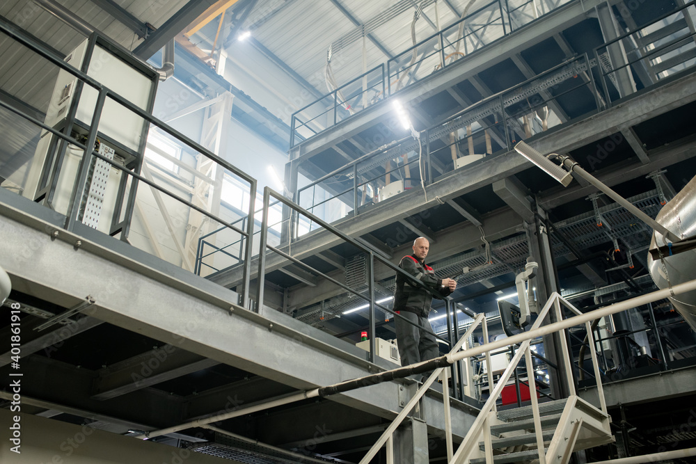 Bald mature engineer or foreman of large contemporary industrial plant Bald mature engineer or foreman of large contemporary industrial plant