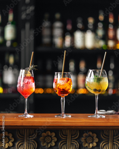 Side view on three glasses of different fruit cocktails on the bar desk