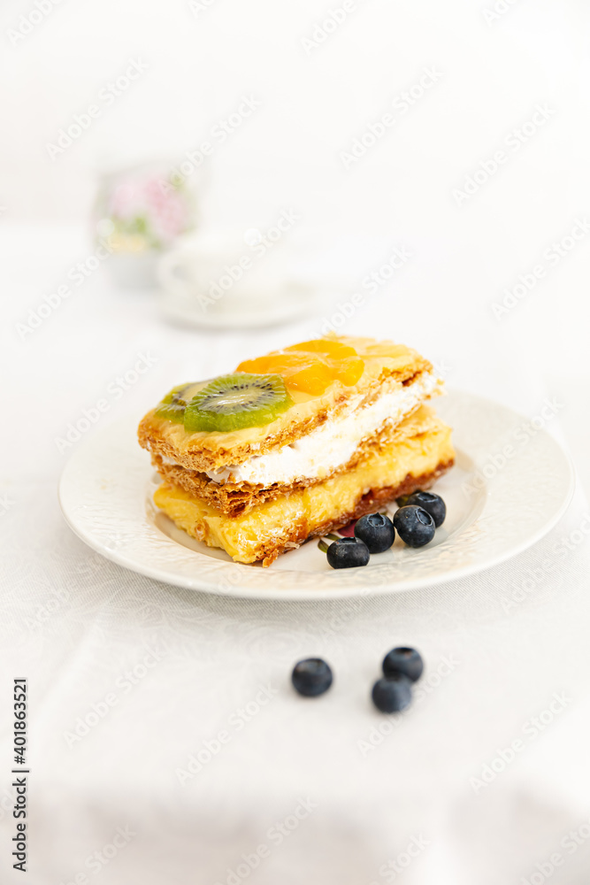 Cream and cream dessert with fruits. Kiwi, peach and blueberries. Cream and cream dessert with fruits. Kiwi, peach and blueberries.
