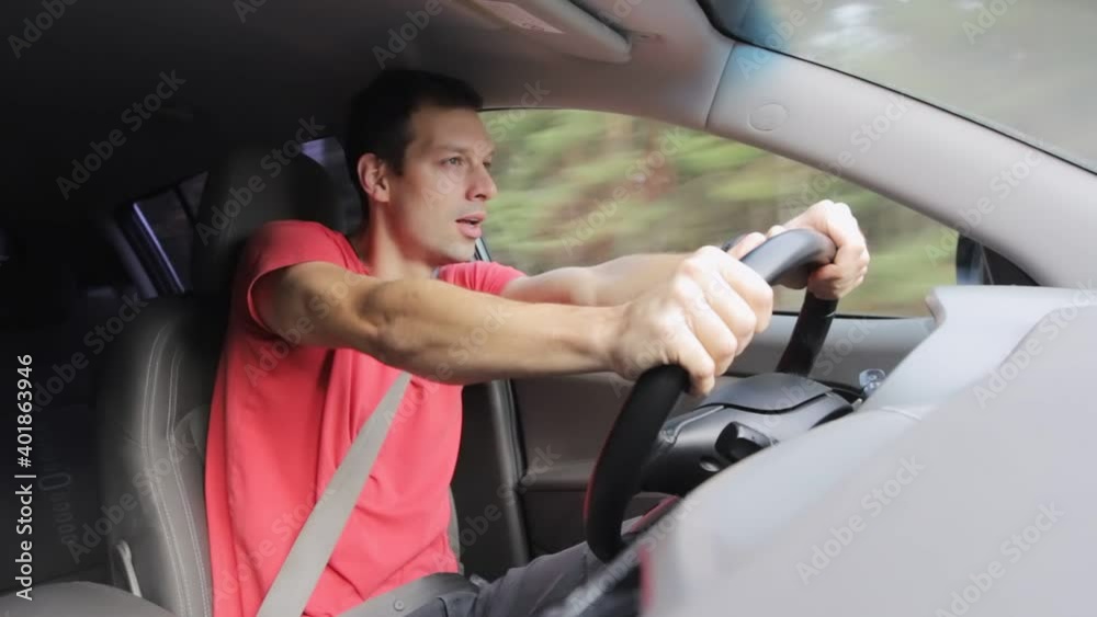 Young male driver speeding very fast in car on forest road. Inside view vehicle Young male driver speeding very fast in car on forest road. Inside view vehicle