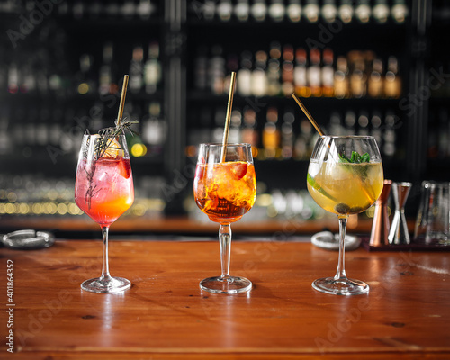 Side view on three glasses of different fruit cocktails on the bar desk