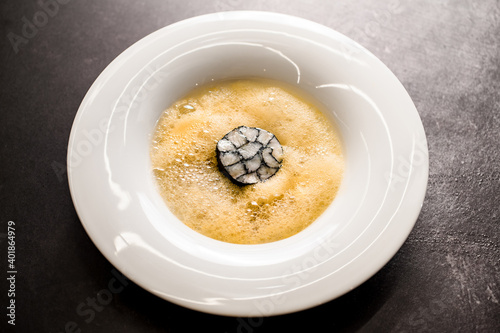 Fototapeta Naklejka Na Ścianę i Meble -  view of plate with yellow foam and with large sushi roll inside