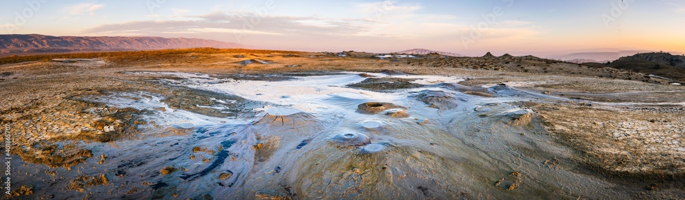 Wide panoramic view of Chachuna mud volcanoes with vibrant colors