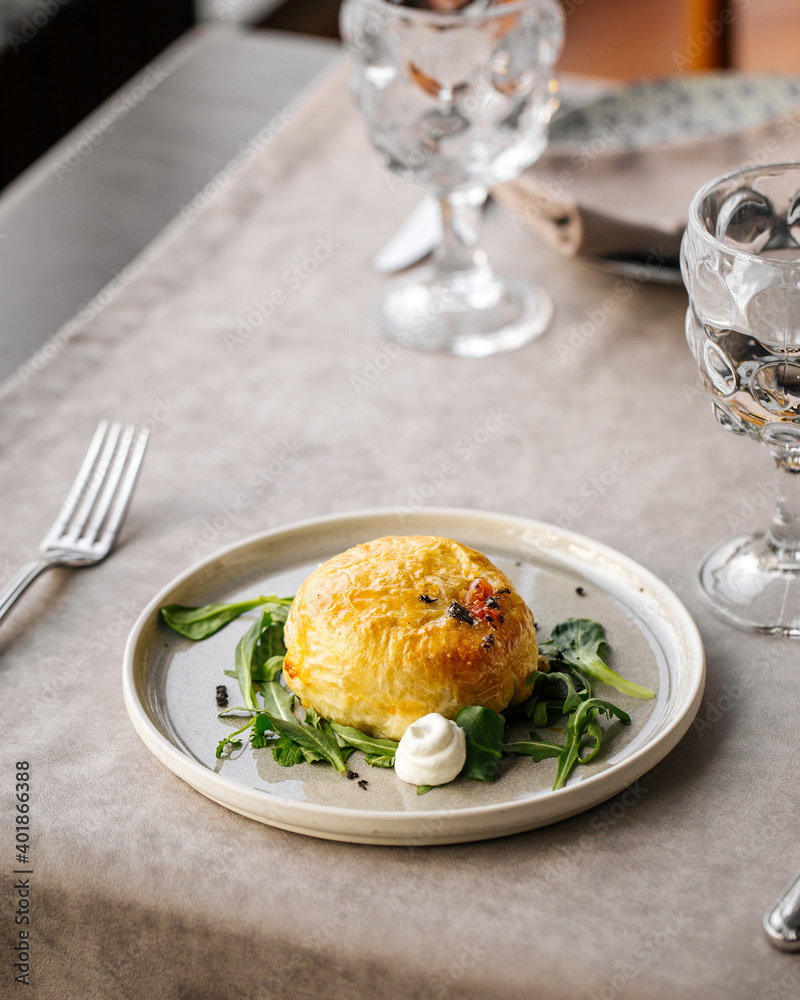 Baked camembert cheese in puff pastry on the served table Baked camembert cheese in puff pastry on the served table