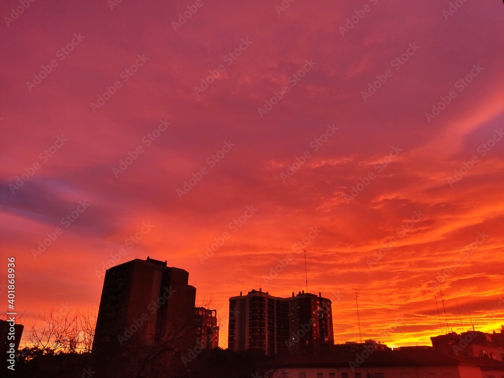 red sky in a sunset over the city where it seems like a day of apocalypse with fire or hell in the sky